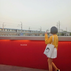 Minimalist white canvas tote bag with cartoon face print on yellow sweatshirt outfit
