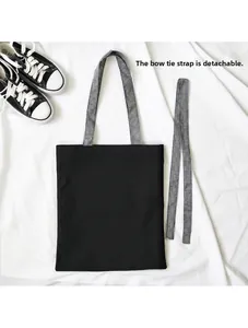 Detail of canvas tote with removable black and white checkered bow-tie decorative strap