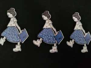 Detail of cute cartoon girl printed patches on high-quality black canvas fabric