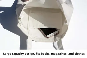 Close-up of canvas tote bag interior showing a practical inner pocket holding a smartphone