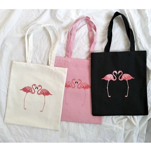 Minimalist canvas tote bags with pink flamingo heart prints in cream, pink and black