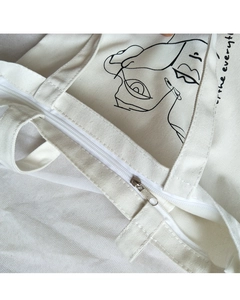 Minimalist canvas tote bag with artistic portrait print and secure silver metal zipper