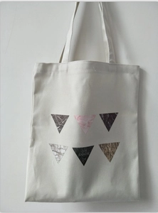 Minimalist white canvas tote bag with geometric marble print and dual shoulder straps