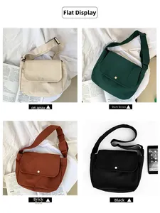 Detailed flat lay of canvas messenger bags in cream, green, red, and black with flap design