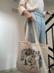 Harajuku-style beige canvas tote bag with hand-drawn art and slogan for daily casual use