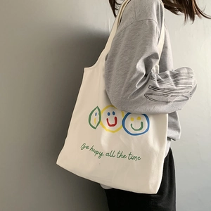 Minimalist white canvas tote bag with smiling faces and Be happy all the time text print