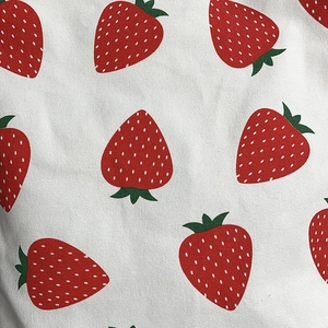 Close-up of strawberry print fabric showing high-quality canvas texture and red patterns