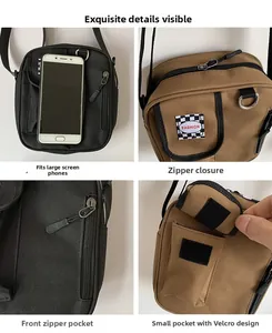 Detail of durable canvas crossbody bag showing multi-pocket design and front zipper