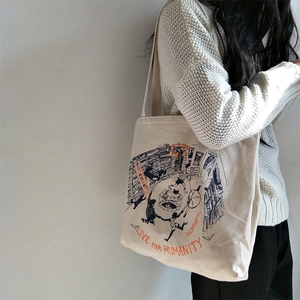 Minimalist canvas tote bag with artistic blue illustration and orange lettering