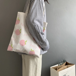 Minimalist white canvas tote bag with pink peach print and fairy text for casual wear
