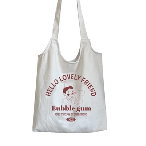 Canvas tote bag with vintage red print of a boy blowing bubbles and long shoulder straps