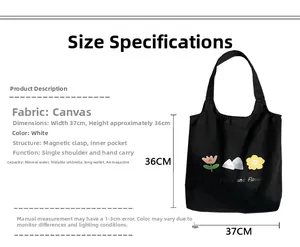 Detail view of black canvas tote showing 37x36cm size with Peaks and Flowers print