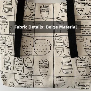 Detail of beige canvas tote fabric featuring black graphic prints and sturdy woven handles