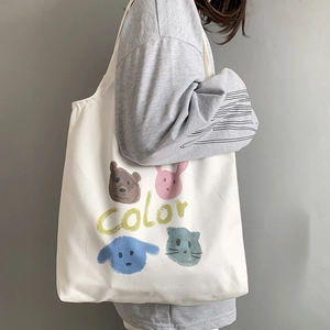 Detail view of canvas tote bag featuring cute hand-drawn cartoon animals and color text