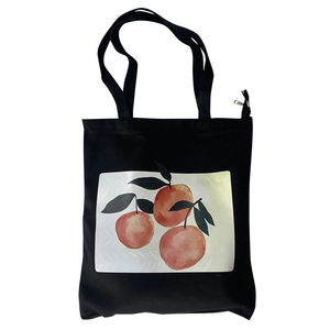 Chic black canvas tote bag with orange fruit print and secure zipper closure