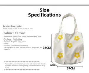 Detail showing white canvas tote bag dimensions with yellow floral prints and magnetic buckle