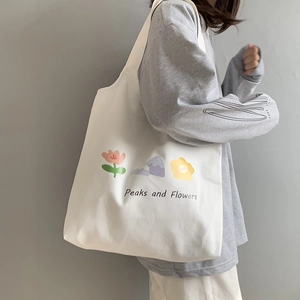 Off-white canvas tote bag featuring Peaks and Flowers print and shoulder strap