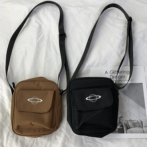 Detail of canvas crossbody bags in black and brown featuring a white planet logo print