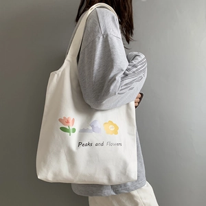Detail of white canvas tote bag featuring Peaks and Flowers colorful graphic print
