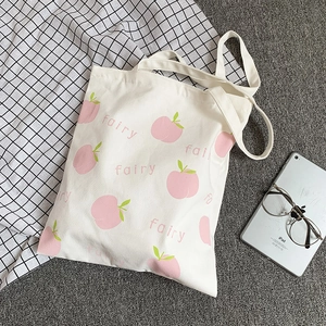 Detailed close-up of the peach print and fairy text on the white canvas tote bag