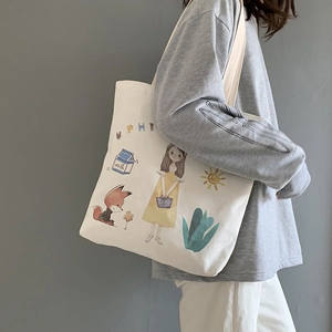 Detailed view of white canvas tote bag featuring cute girl and fox hand-drawn illustrations