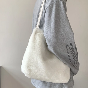 Détail du sac cabas en fausse fourrure blanche montrant la texture et la capacité