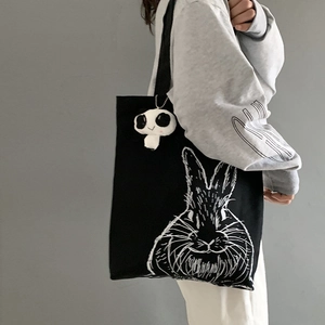 Japanese style black canvas tote bag with rabbit illustration and plush panda pendant