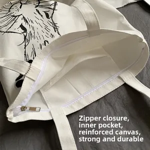 Detail view of the canvas tote bag showing the zipper closure and internal pocket compartment