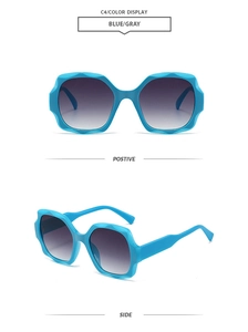 Close-up of stylish wavy blue square frame sunglasses with gradient grey lenses