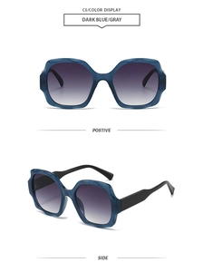 Detail of dark blue oversized square sunglasses with geometric frames and gray lenses