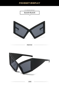 Detail view of black oversized geometric butterfly sunglasses with dark tinted lenses
