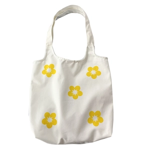 Minimalist white canvas tote bag featuring five yellow floral prints for women