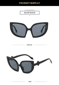 Detail of cat eye sunglasses with wavy temples and metallic stud accents on black frames