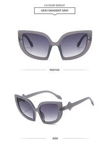 Front and side view of cat-eye sunglasses with grey gradient lenses and metal studs