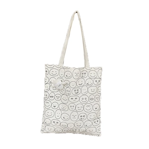 White canvas tote bag with funny emoji prints and a cute plush lamb pendant
