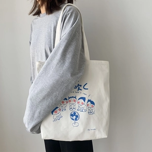 Close-up of Japanese cartoon illustration on a cream canvas shoulder bag