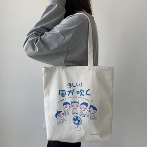 Close-up of Japanese style canvas tote bag featuring cute cartoon print and thick straps