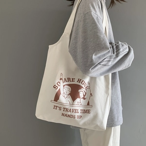 White canvas tote bag with brown character print for daily commute and student use