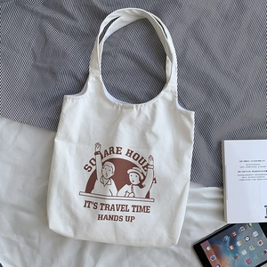 White canvas tote bag with brown cartoon illustration and Square House lettering