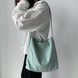 Minimalist mint green nylon shoulder bag with large capacity and crescent shape