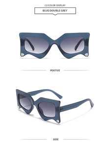 Macro view of blue geometric sunglasses with diamond inlay and wavy frame details
