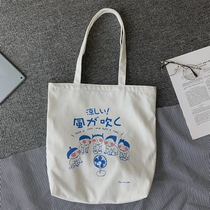 Japanese style white canvas tote bag featuring a cute blue cartoon character illustration