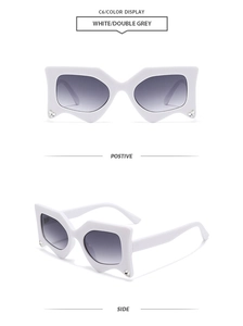 Detail view of white geometric butterfly sunglasses featuring side rhinestones and grey lenses