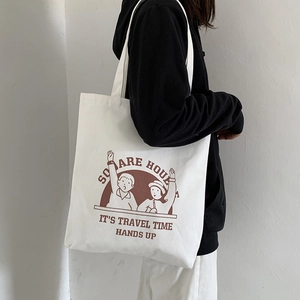 Detail of white canvas tote bag with vintage illustration and sturdy shoulder straps