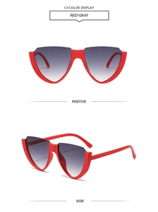 Detail view of red semi-rimless shield sunglasses with gray gradient lenses