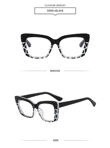 Detail view of cat eye glasses frames with black and spotted cow print pattern