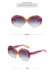 Detail view of oval gradient sunglasses with stylish purple and green frames