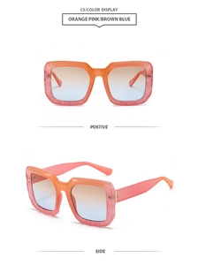 Detail of square sunglasses with pink-orange marble frames and gradient lenses