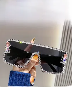 Detail view of grey square oversized sunglasses with rhinestones and butterfly accents