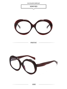 Close-up of wine red oval sunglasses showing front and side views in retro thick frame